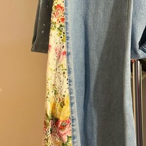 Denim jean featuring elegant floral embroidery.